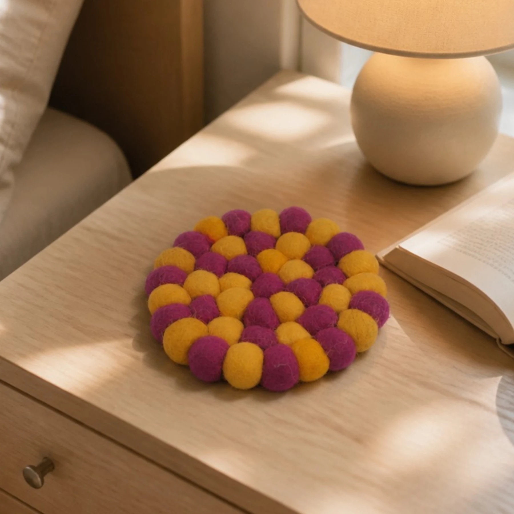Colorful felt coaster on a bedside table